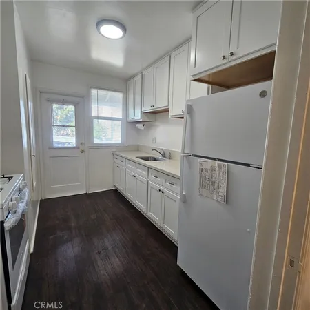a kitchen with a refrigerator and a stove