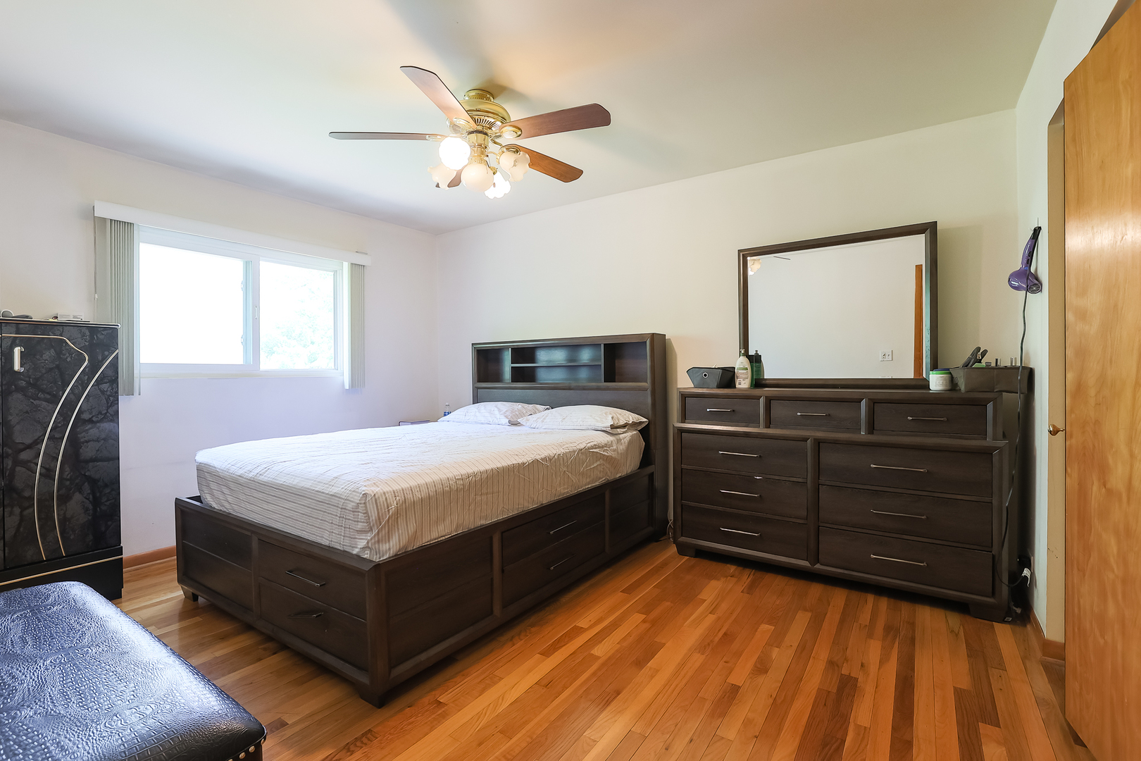 9461 Dee Road Des Plaines, IL 60016 - Photo 12 of 26 a bedroom with a bed and wooden floor