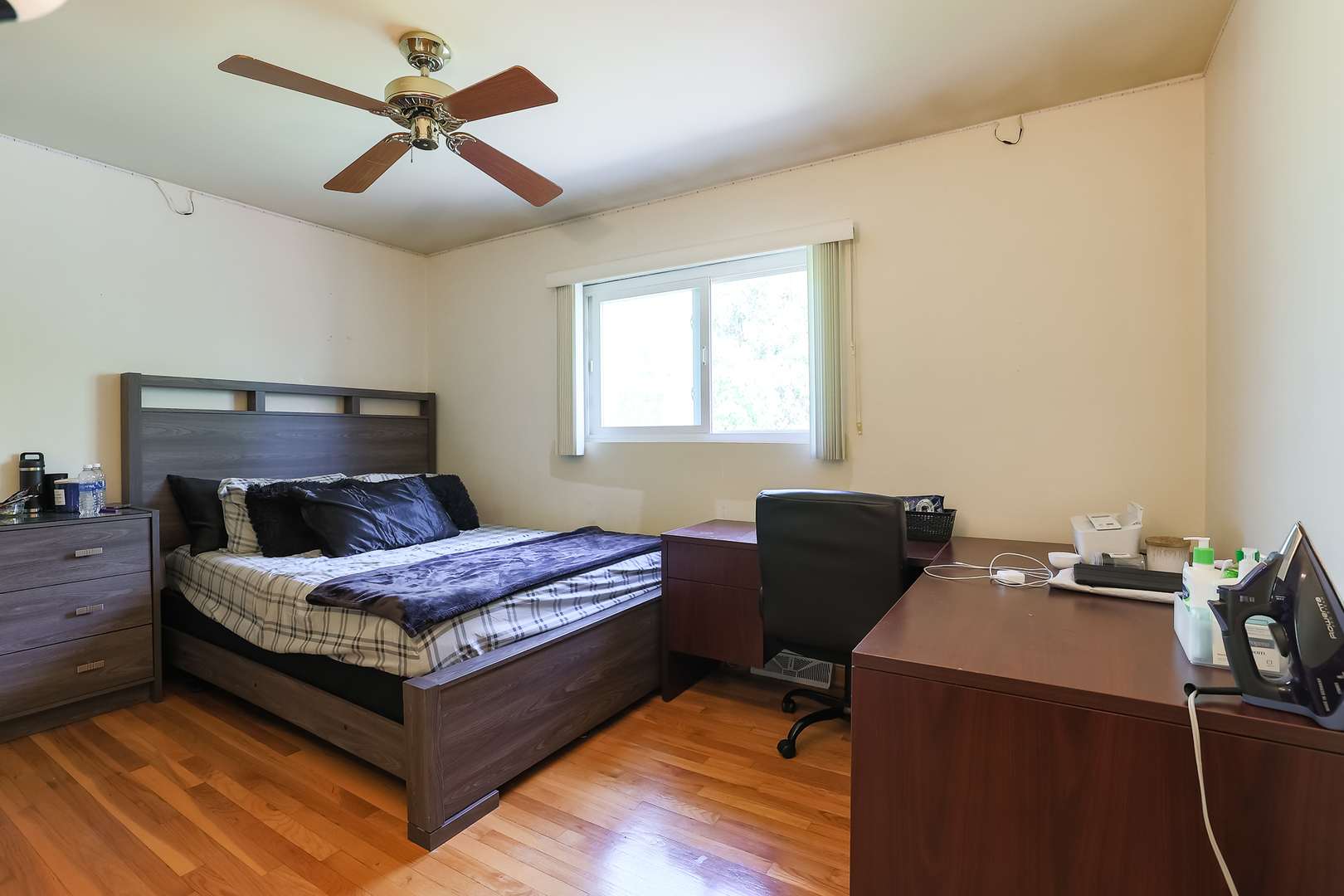 9461 Dee Road Des Plaines, IL 60016 - Photo 13 of 26 a bedroom with a bed and a chandelier