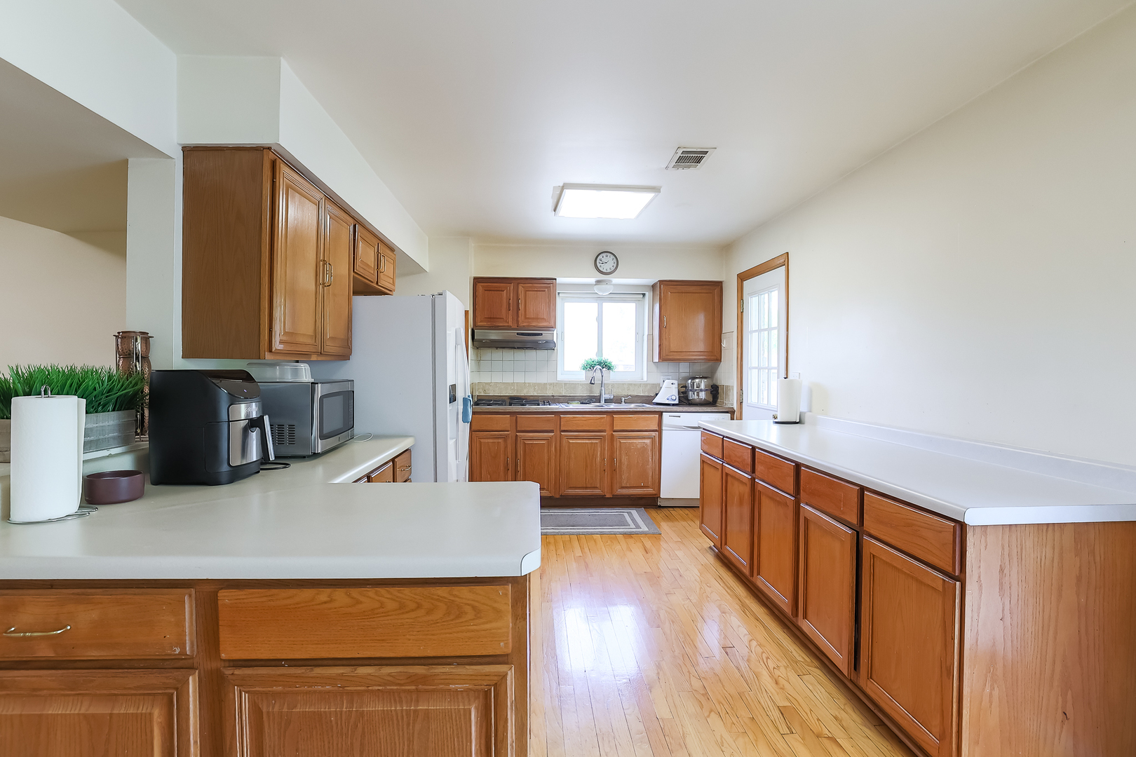 9461 Dee Road Des Plaines, IL 60016 - Photo 18 of 26 a kitchen with counter top space a sink cabinets and appliances