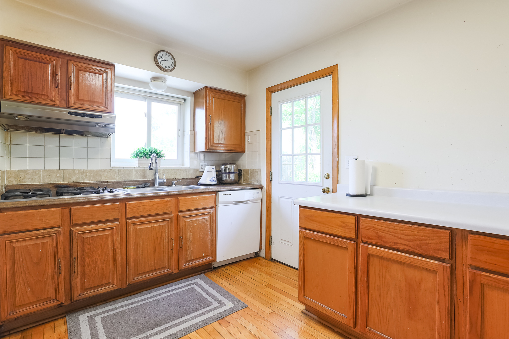 9461 Dee Road Des Plaines, IL 60016 - Photo 20 of 26 a kitchen with granite countertop cabinets stainless steel appliances a sink and a window