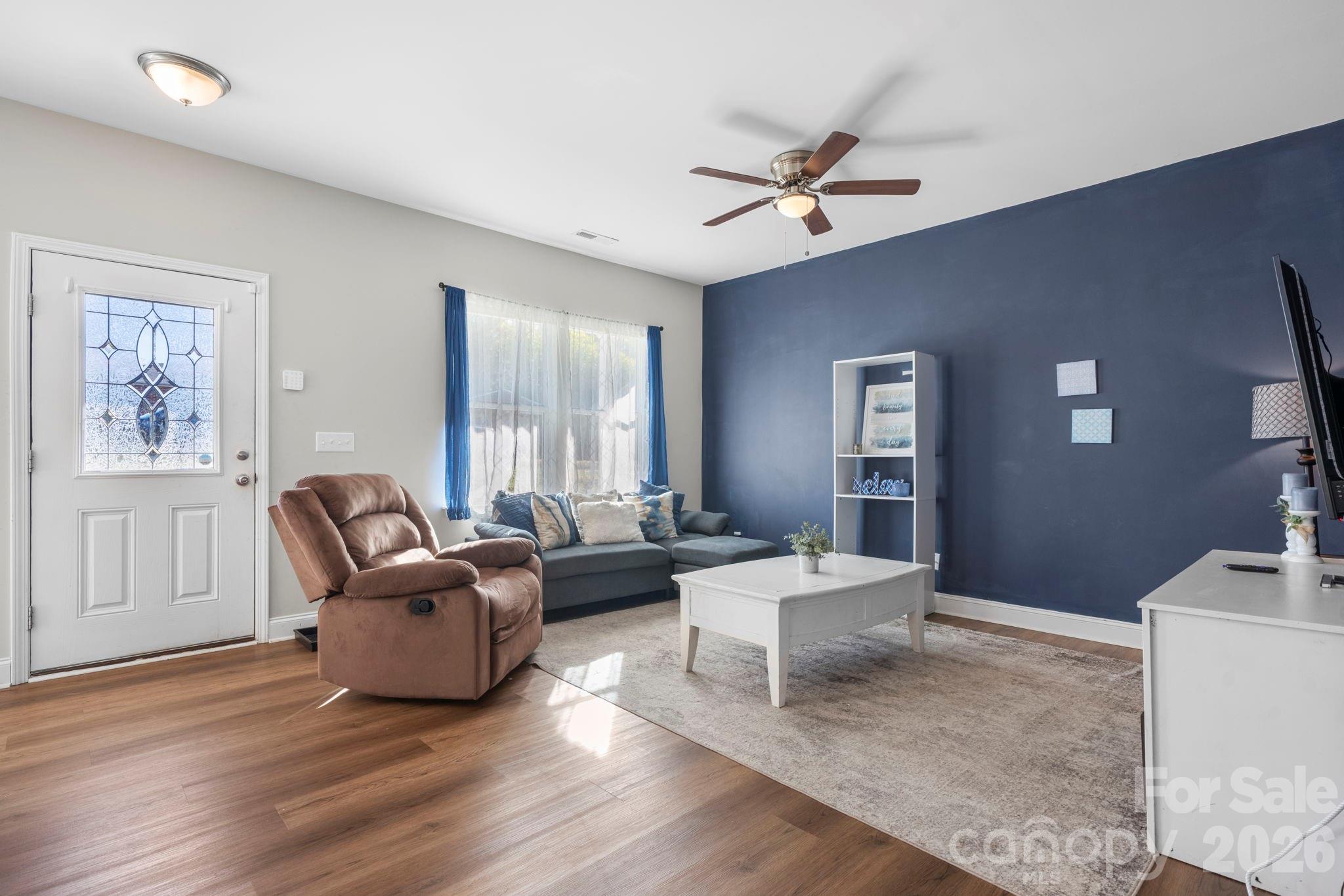 402 2nd Street Southwest Hickory, NC 28602 - Photo 1 of 24 a living room with furniture and three window