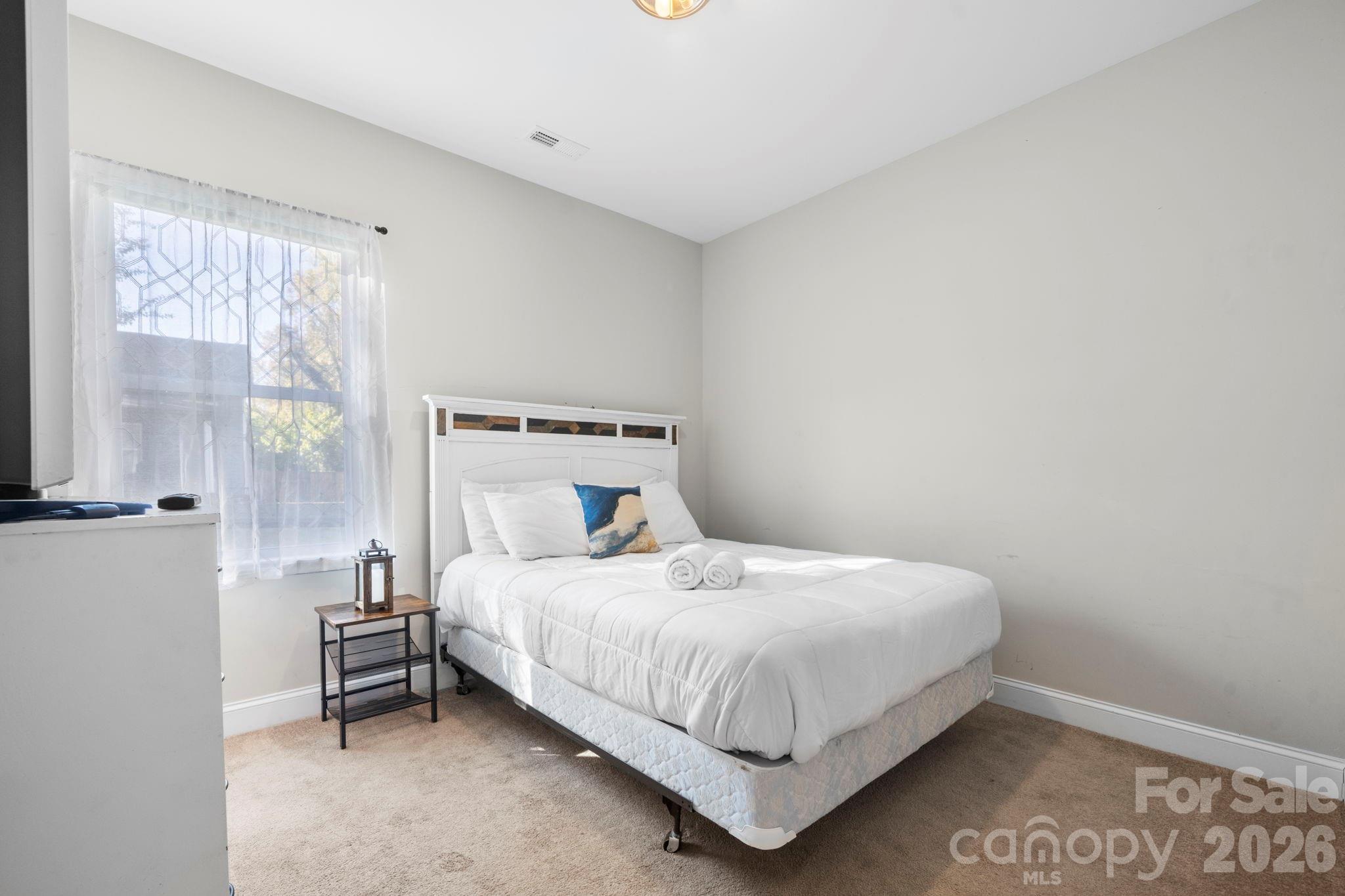 402 2nd Street Southwest Hickory, NC 28602 - Photo 14 of 24 a bedroom with a bed and a window