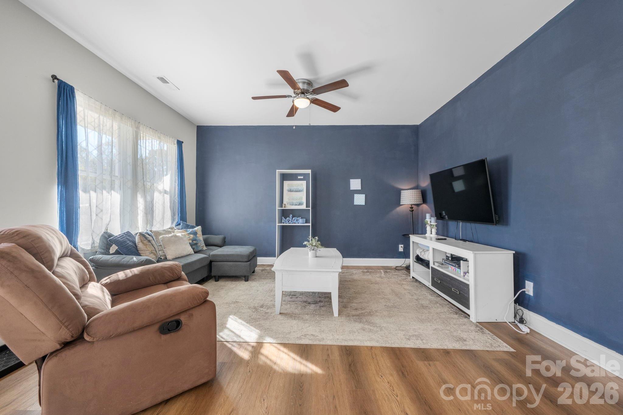 402 2nd Street Southwest Hickory, NC 28602 - Photo 2 of 24 a living room with furniture and a flat screen tv