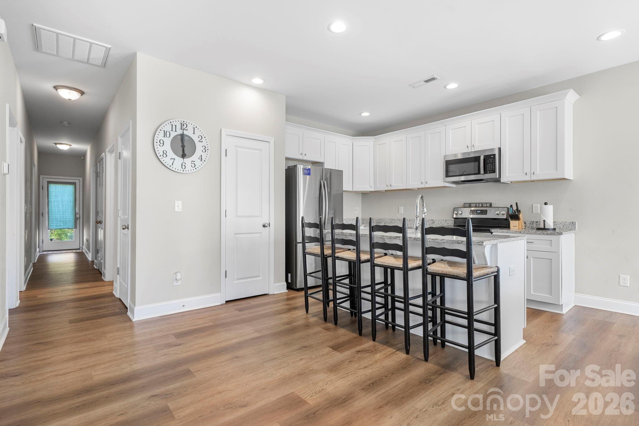 402 2nd Street Southwest Hickory, NC 28602 - Photo 3 of 24 a kitchen with stainless steel appliances a refrigerator and microwave