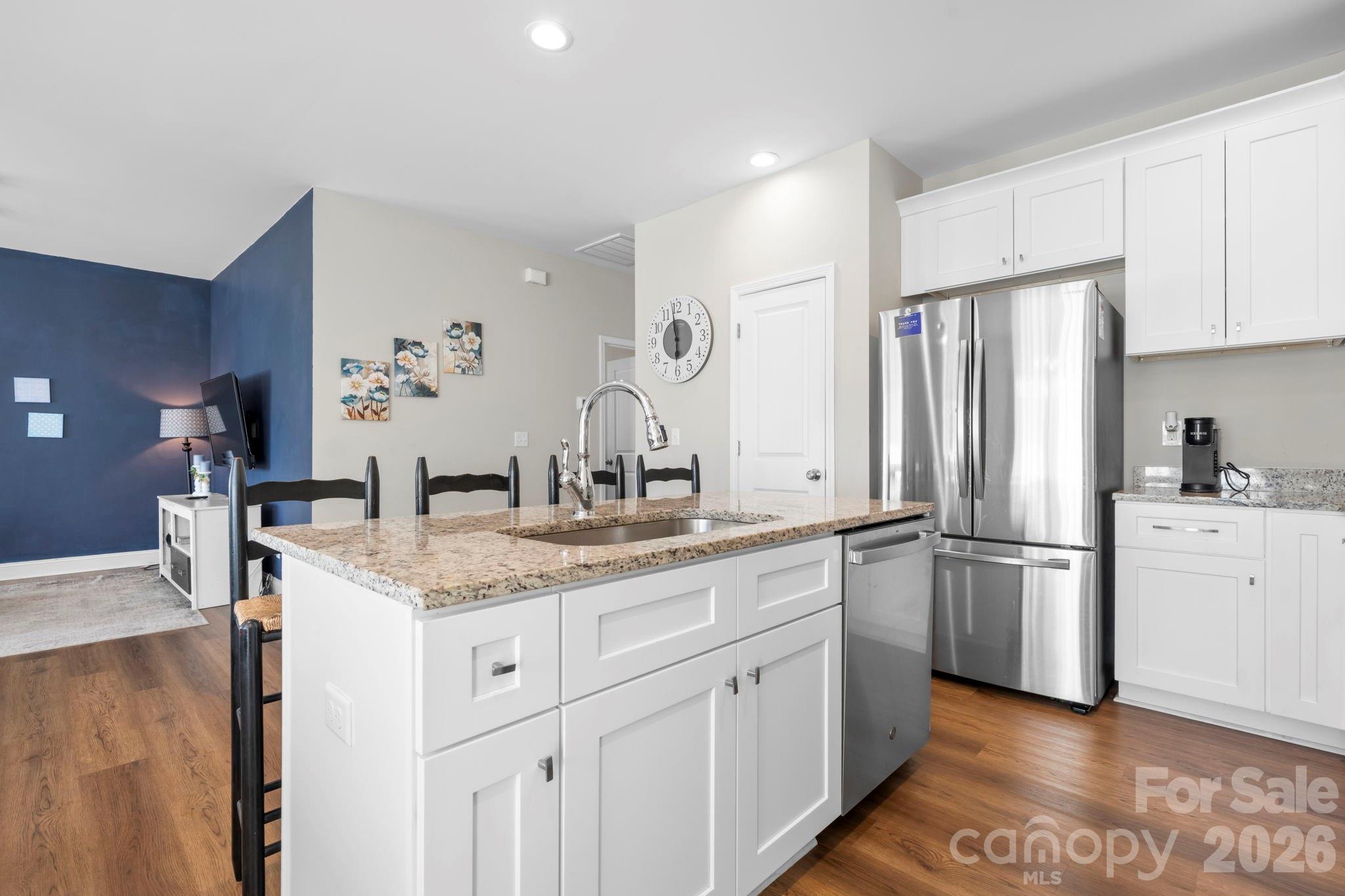 402 2nd Street Southwest Hickory, NC 28602 - Photo 4 of 24 a kitchen with white cabinets and stainless steel appliances