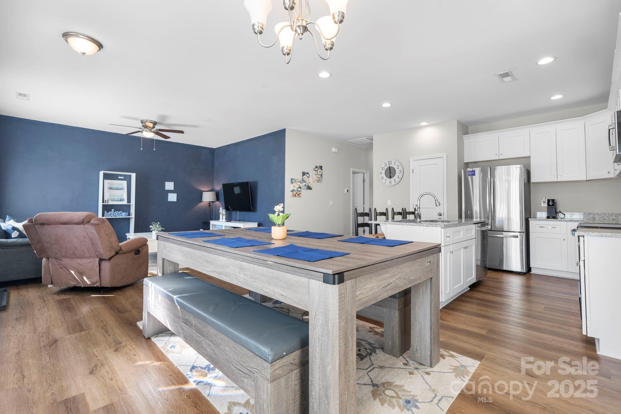 402 2nd Street Southwest Hickory, NC 28602 - Photo 6 of 24 a large kitchen with kitchen island a island a stove a sink a dining table and chairs