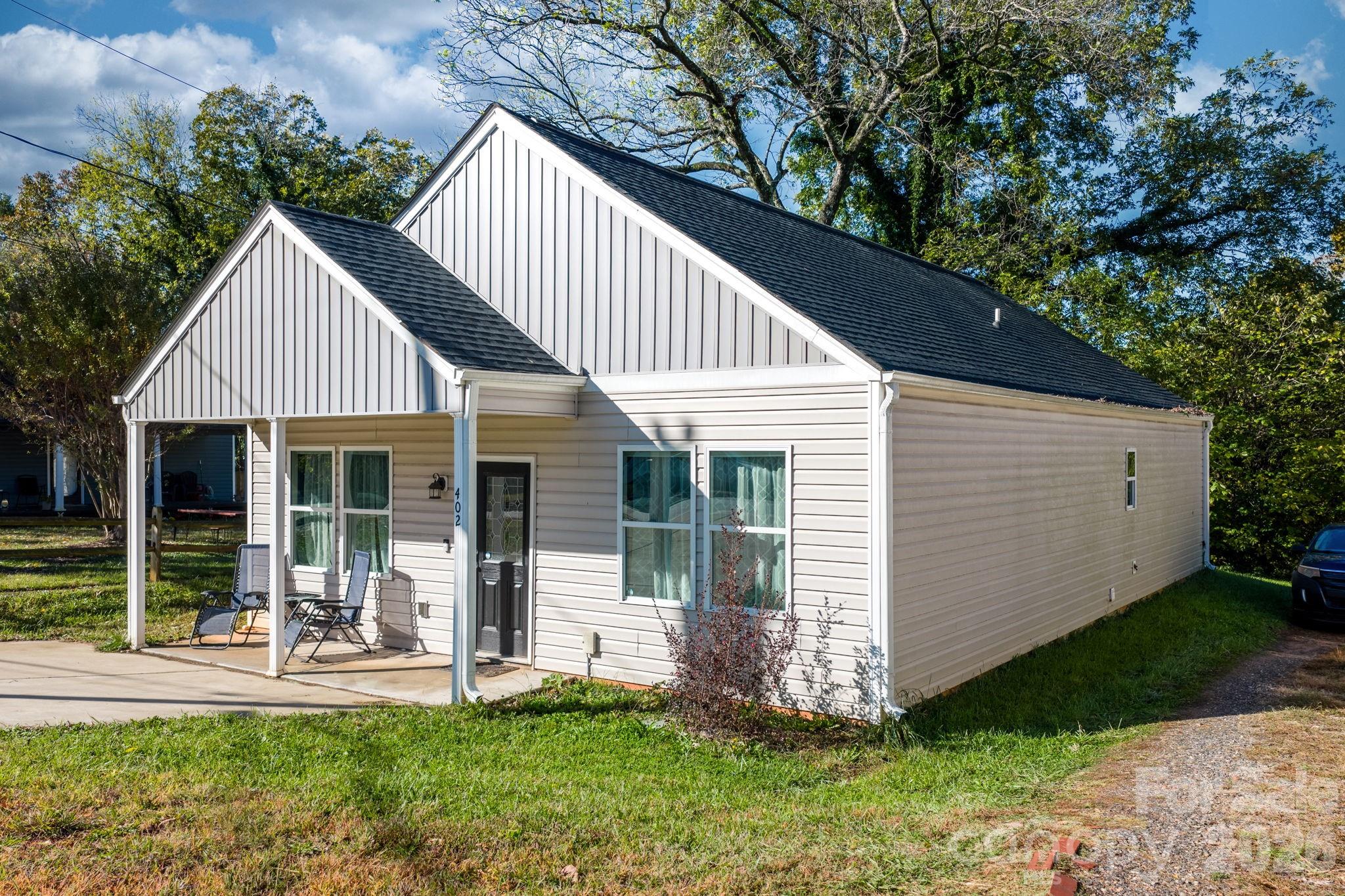 402 2nd Street Southwest Hickory, NC 28602 - Photo 7 of 24 a front view of a house with a yard table and chairs