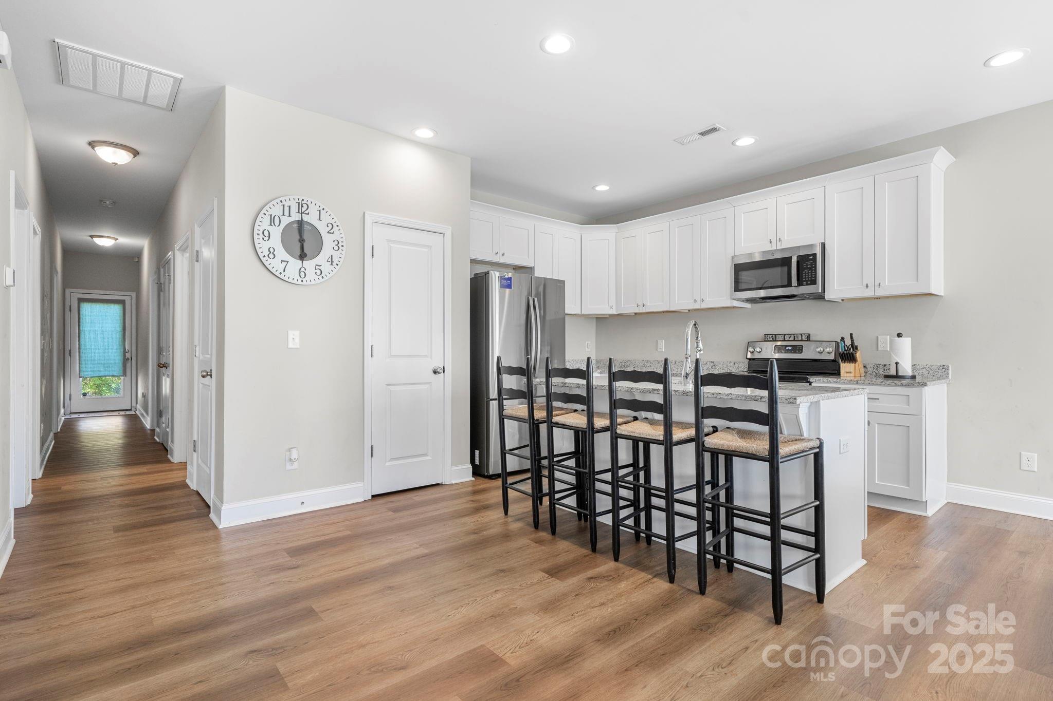 402 2nd Street Southwest Hickory, NC 28602 - Photo 7 of 24 a kitchen with stainless steel appliances a refrigerator and microwave