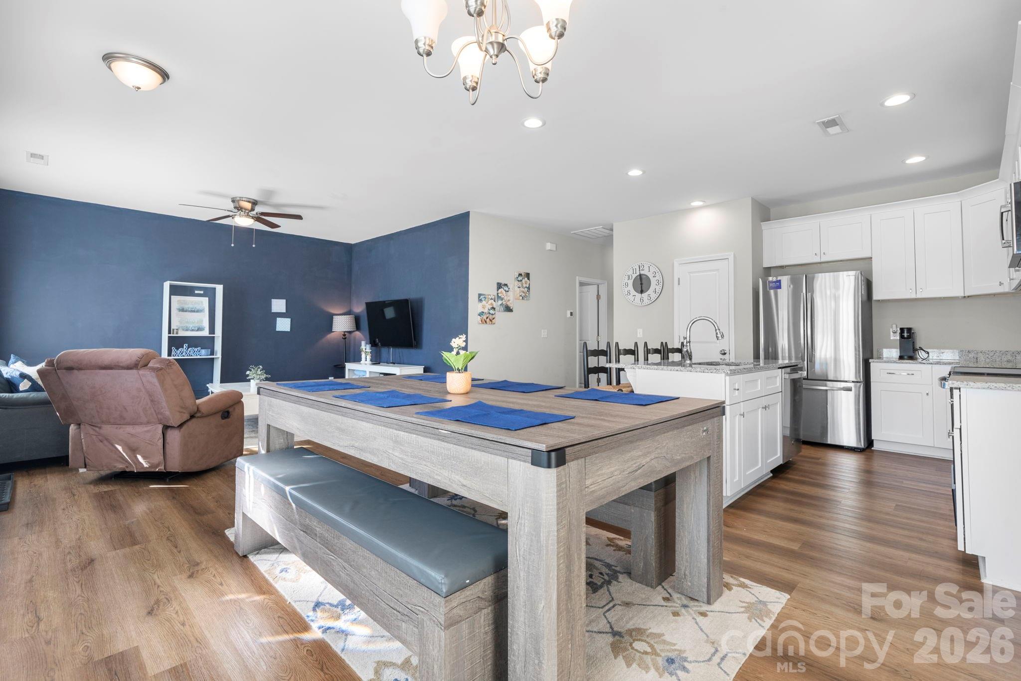 402 2nd Street Southwest Hickory, NC 28602 - Photo 9 of 24 a large kitchen with kitchen island a island a stove a sink a dining table and chairs