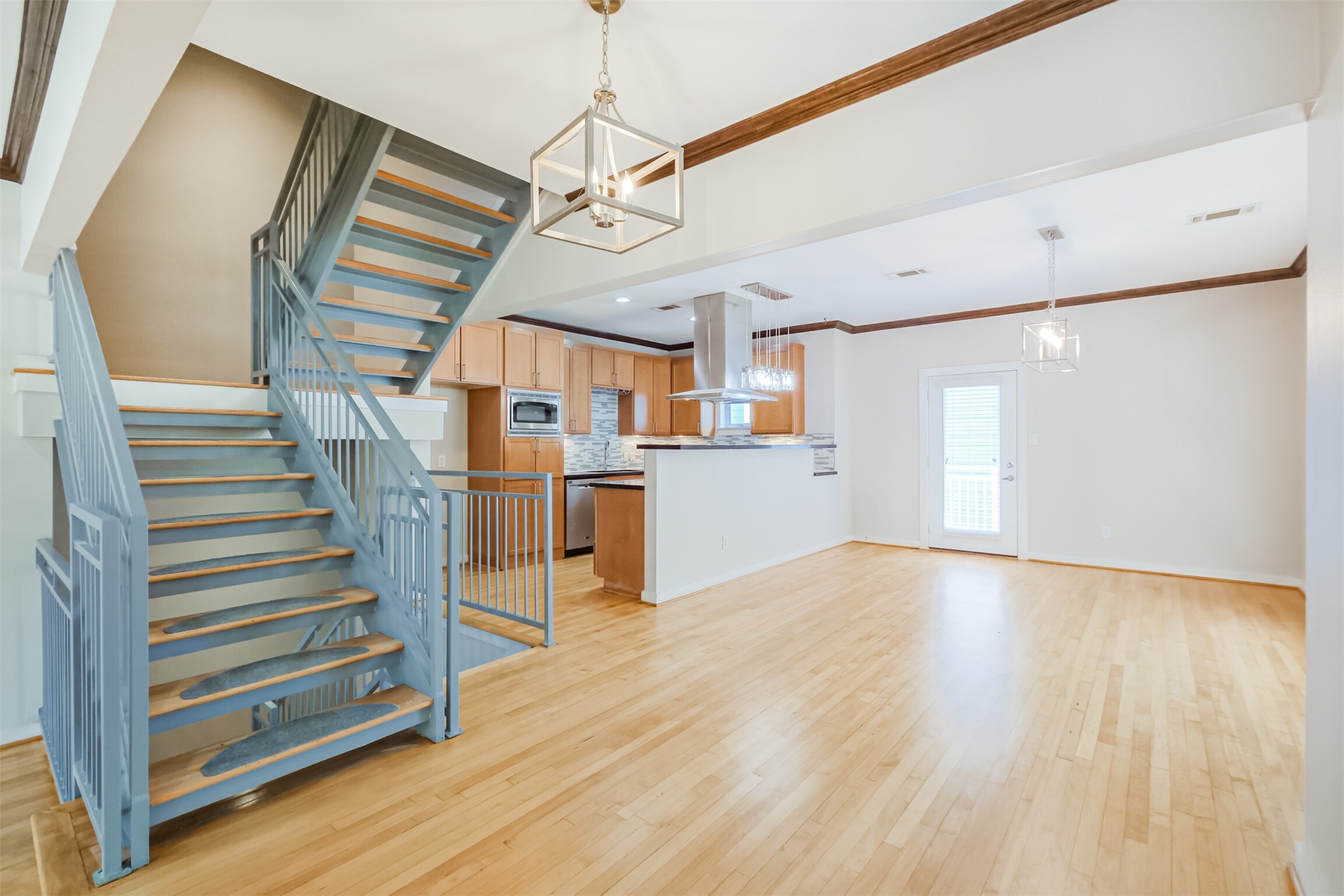 2364 Arlington Street Houston, TX 77008 - Photo 15 of 45 a view of a room with wooden floor stairs and a chandelier