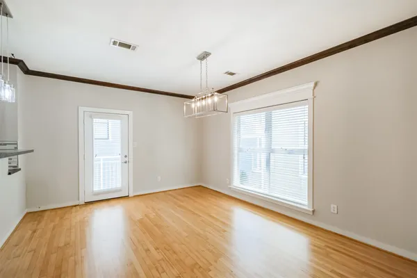 a view of a kitchen with wooden floor and a window