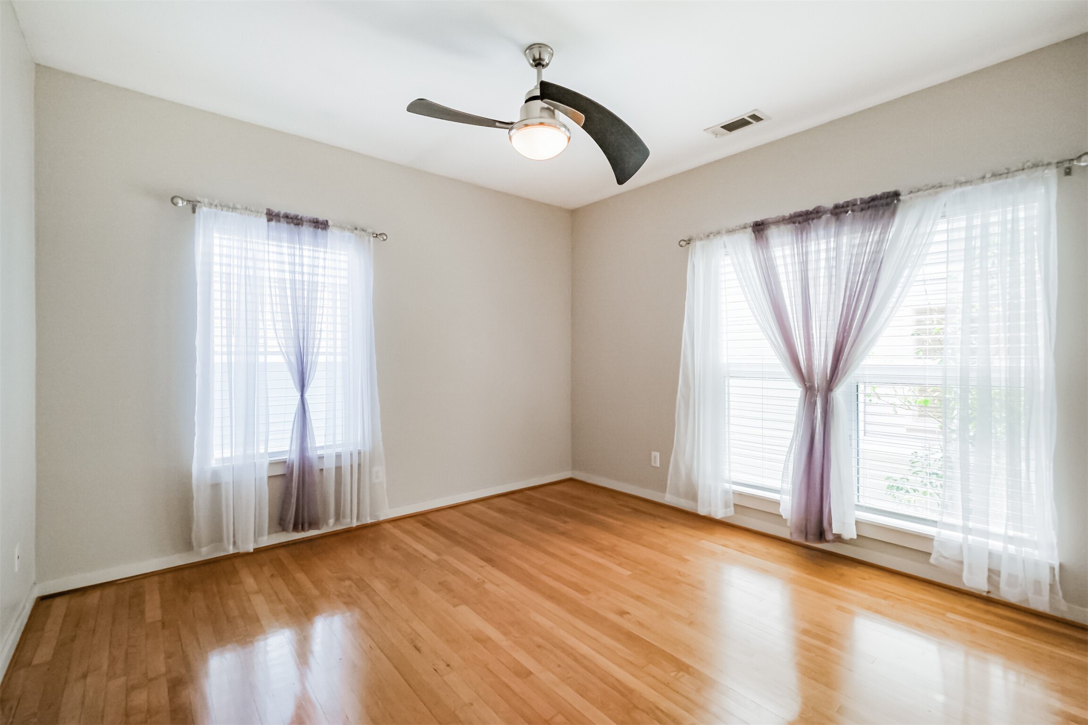 2364 Arlington Street Houston, TX 77008 - Photo 37 of 45 a view of empty room with wooden floor and fan