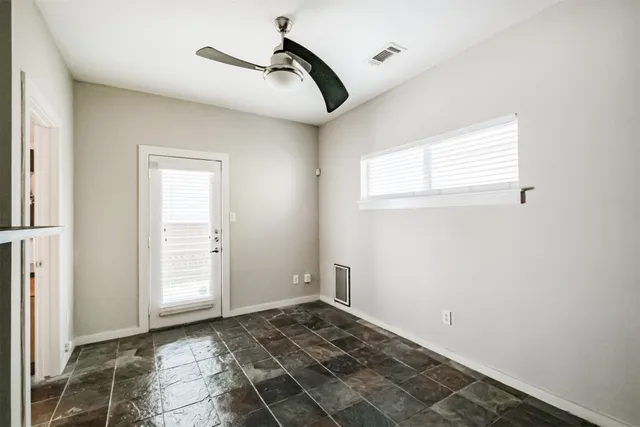 a bathroom with a granite countertop toilet a sink and a mirror