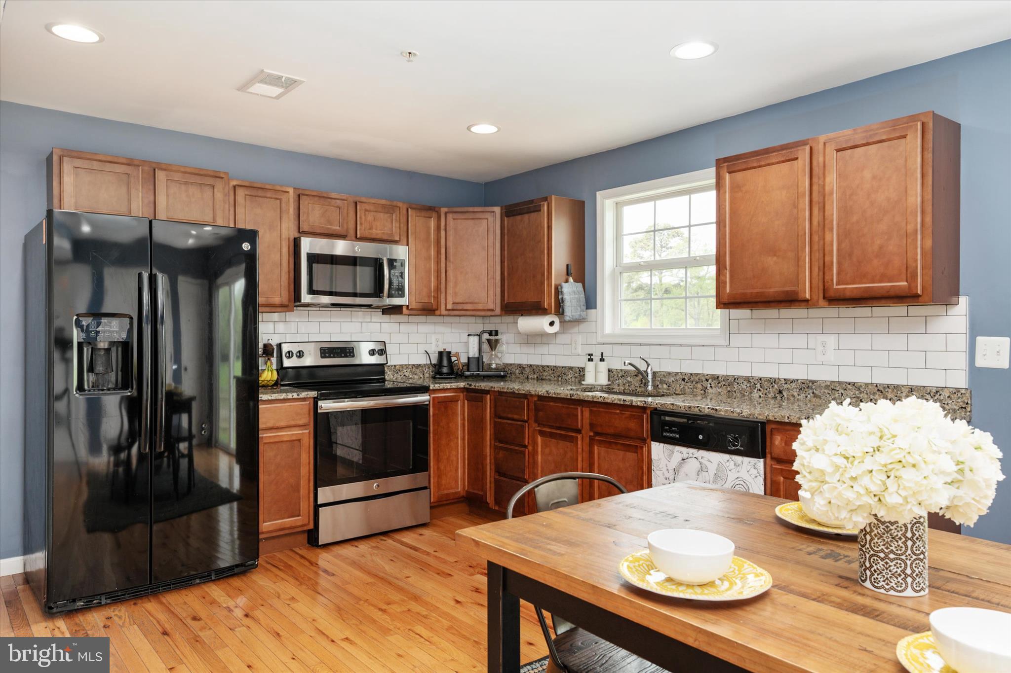 200 Newtown Road Chester, MD 21619 - Photo 14 of 50 a kitchen with stainless steel appliances granite countertop a refrigerator a stove top oven a sink and dishwasher