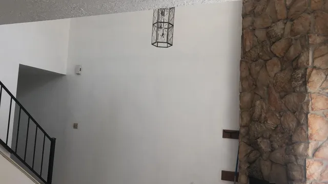 a bathroom with a shower curtain and a window