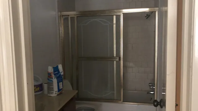 a bathroom with a glass shower door