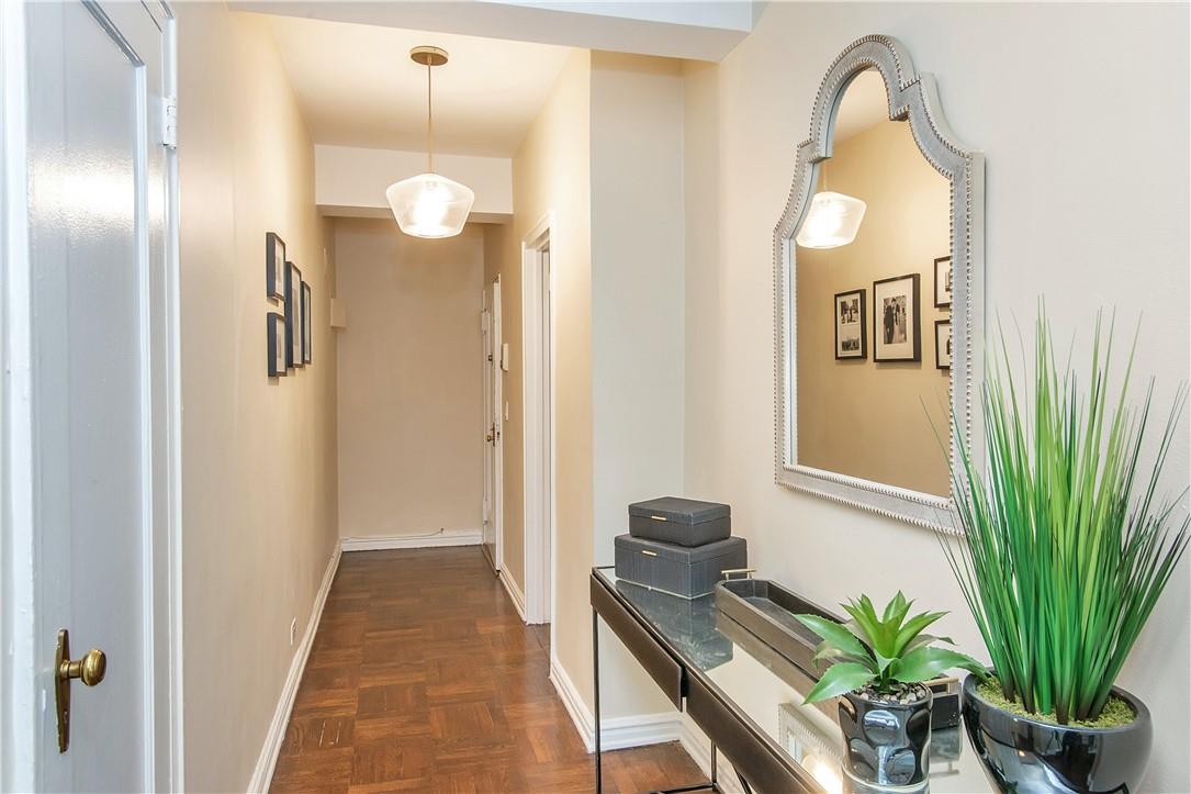 a view of a hallway to a livingroom and a potted plant