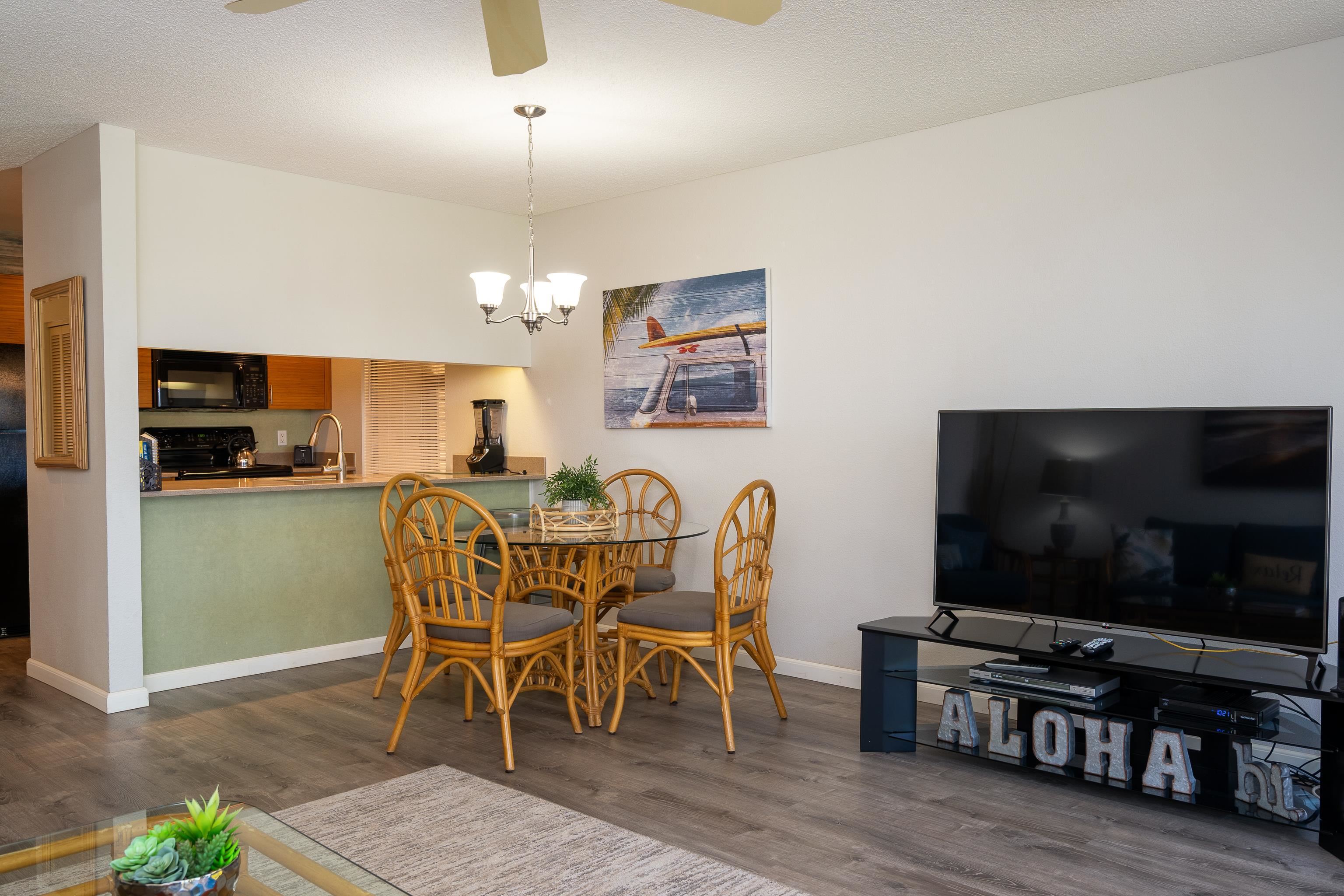2777 South Kihei Road, Unit G101 Kihei, HI 96753 - Photo 11 of 32 a view of a dining room with furniture wooden floor and chandelier