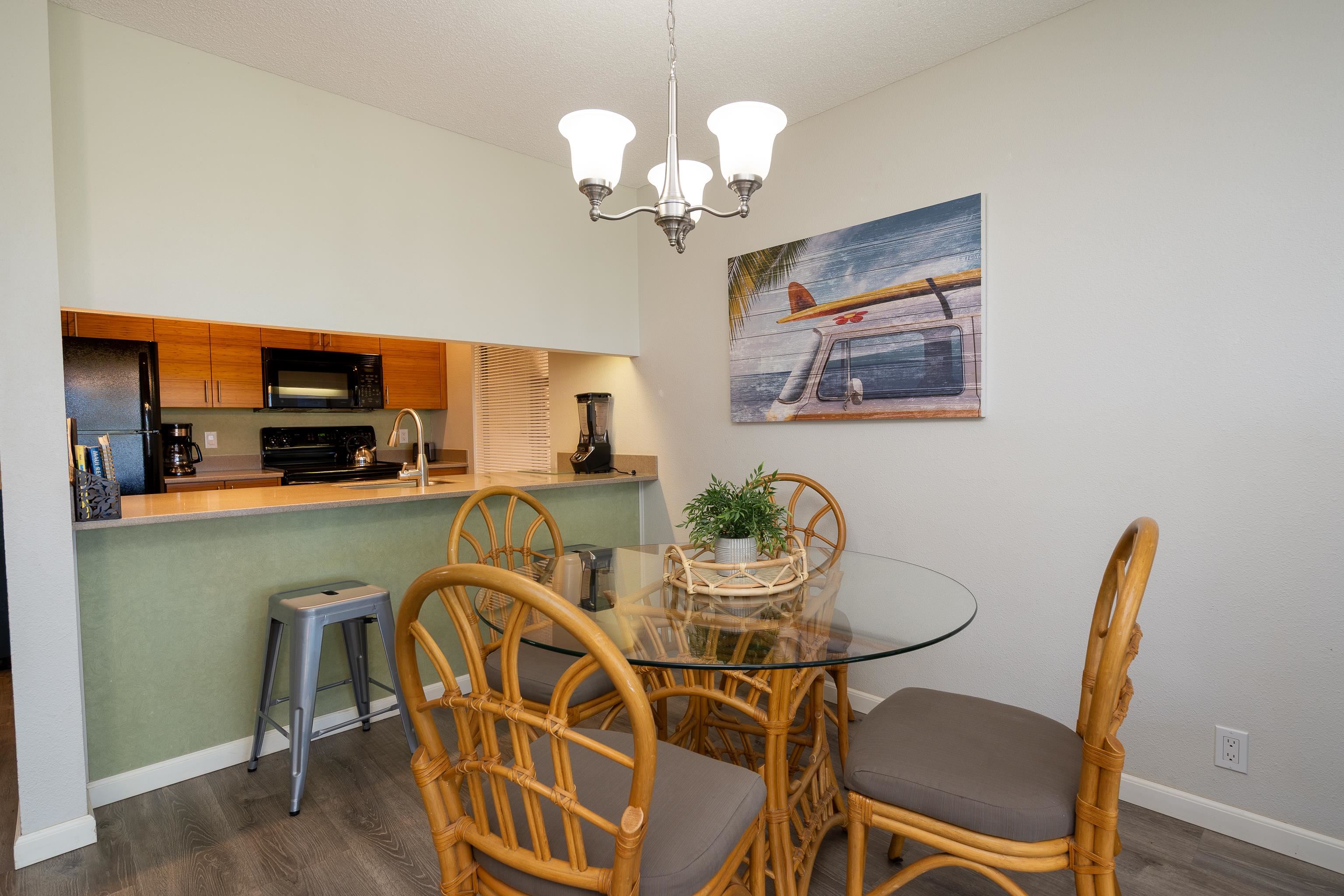 2777 South Kihei Road, Unit G101 Kihei, HI 96753 - Photo 12 of 32 a view of a dining room with furniture and wooden floor