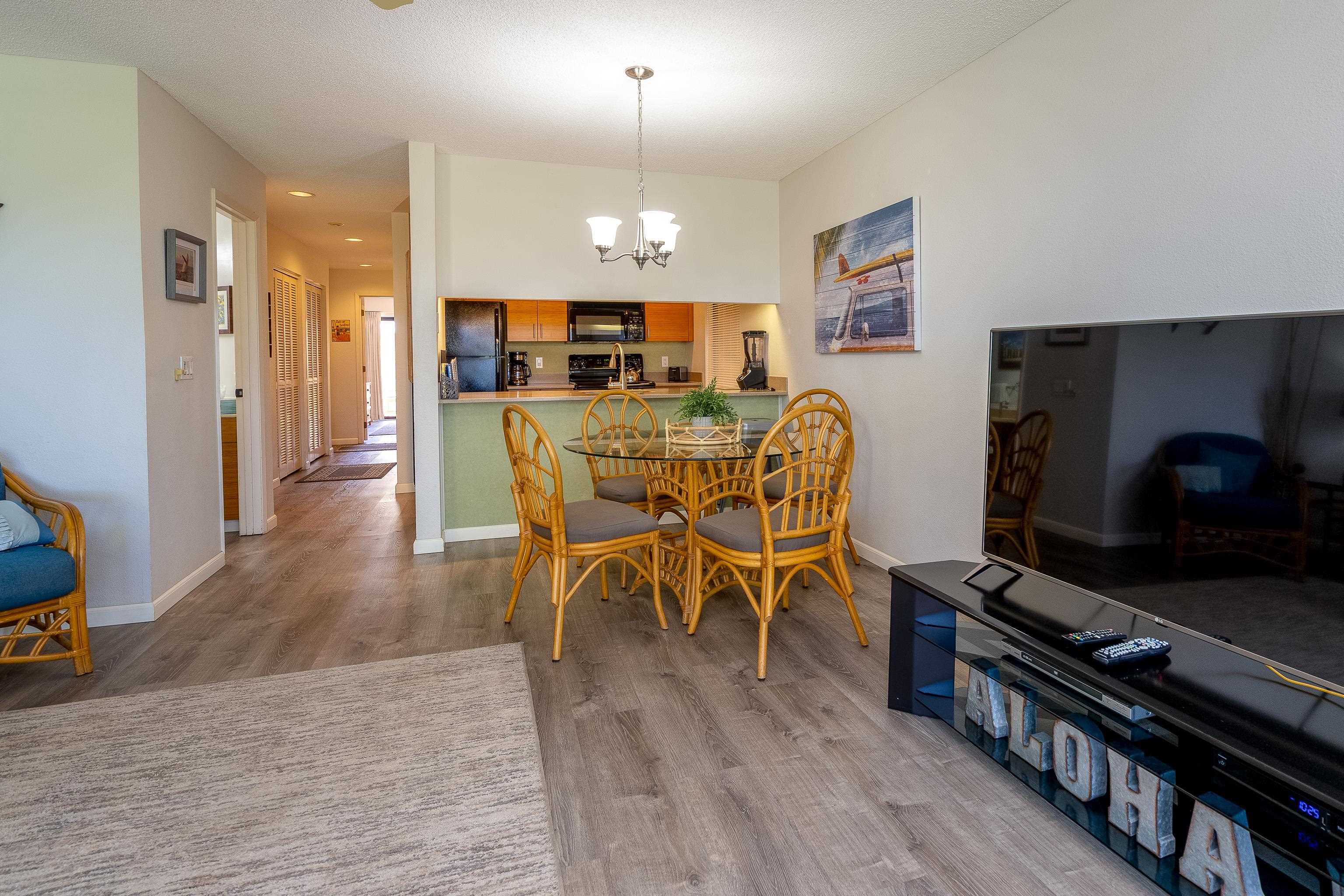 2777 South Kihei Road, Unit G101 Kihei, HI 96753 - Photo 13 of 32 a view of a dining room with furniture and wooden floor