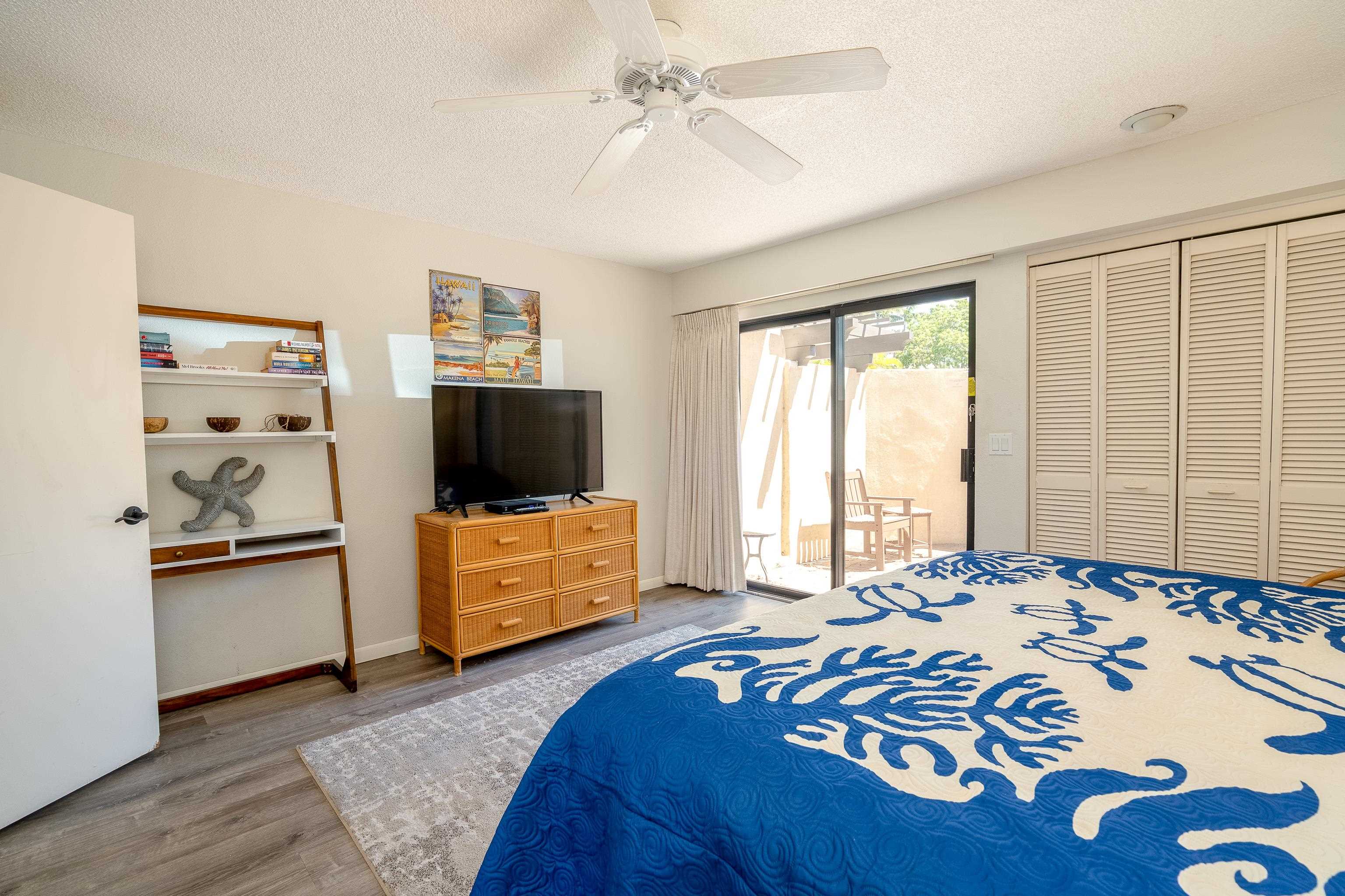 2777 South Kihei Road, Unit G101 Kihei, HI 96753 - Photo 17 of 32 a bedroom with a bed and a flat screen tv