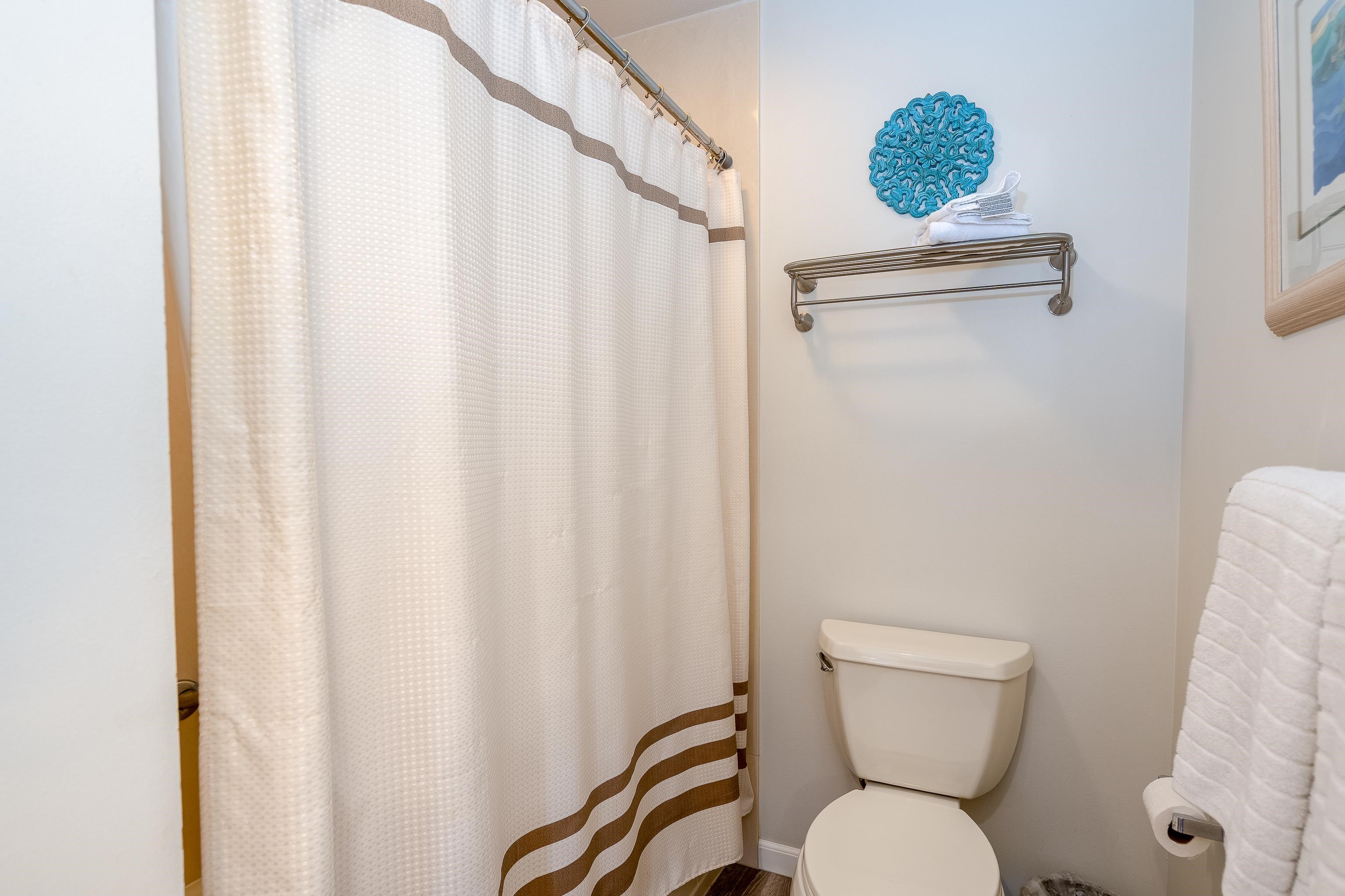 2777 South Kihei Road, Unit G101 Kihei, HI 96753 - Photo 27 of 32 a white toilet sitting next to a shower curtain