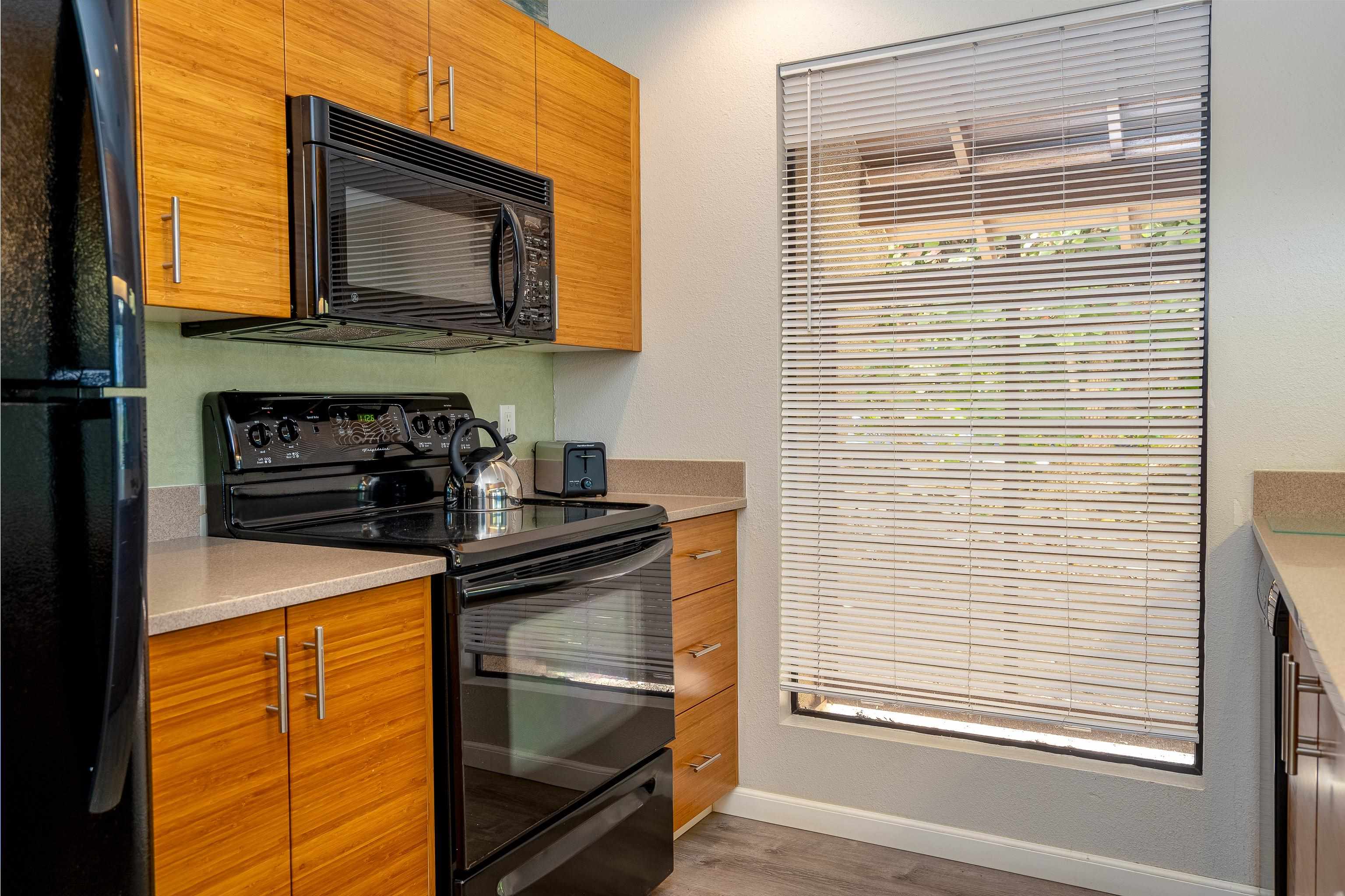 2777 South Kihei Road, Unit G101 Kihei, HI 96753 - Photo 4 of 32 a kitchen with a stove and a microwave