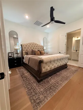 a bedroom with a bed lamp and dresser