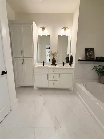 a large white tub sitting in a bathroom