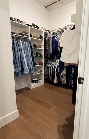 a view of walk in closet with clothes