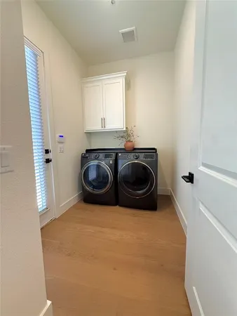 a utility room with two washing machine