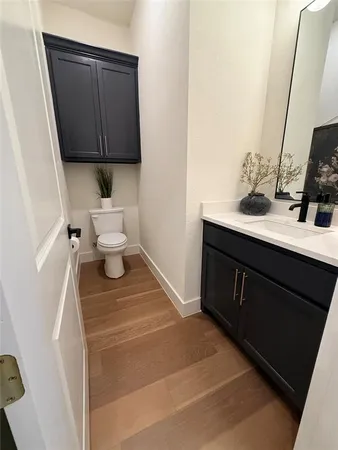 a bathroom with a sink toilet and mirror