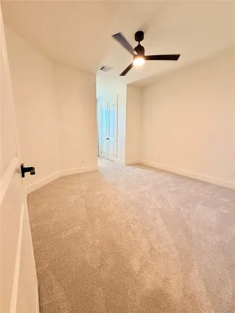 a view of a room with a ceiling fan