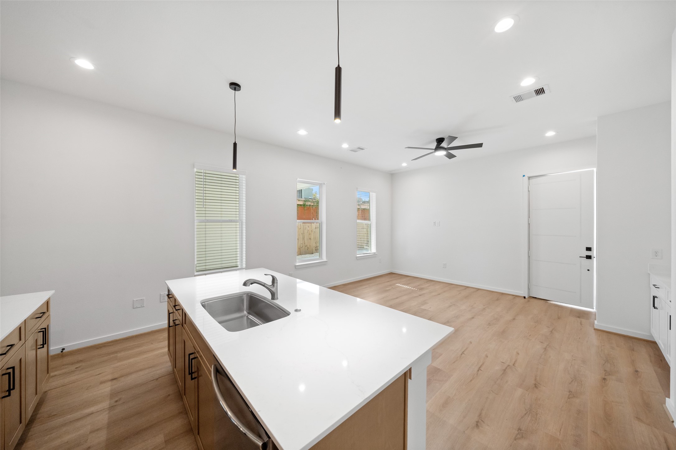 1408 Enid Street, Unit C Houston, TX 77009 - Photo 11 of 27 a kitchen with a stove a sink a kitchen island with wooden floor