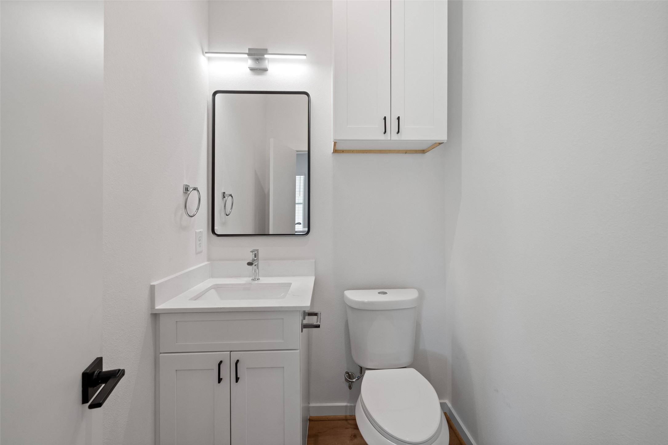 1408 Enid Street, Unit C Houston, TX 77009 - Photo 13 of 27 a bathroom with a toilet sink and mirror