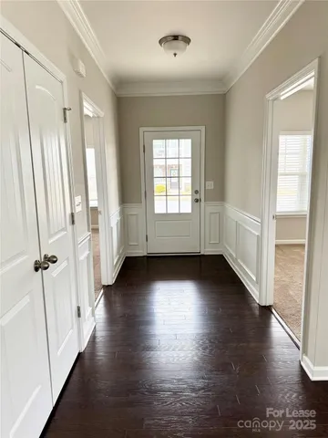 an empty room with wooden floor and window