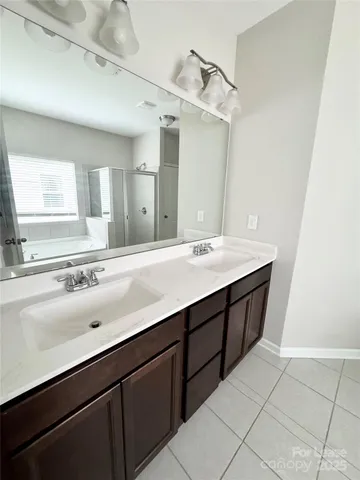 a bathroom with a sink double vanity and a mirror