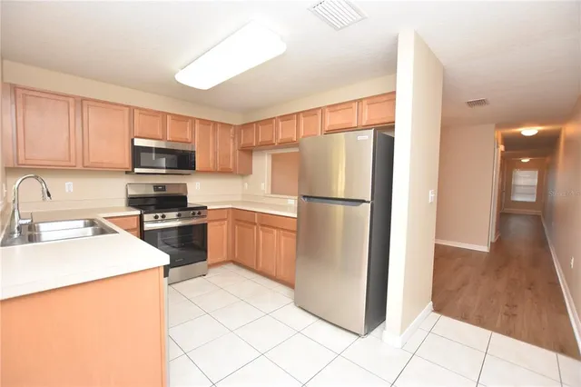 a kitchen with a refrigerator sink and microwave