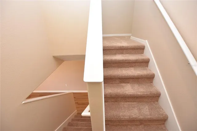 a view of staircase with white walls
