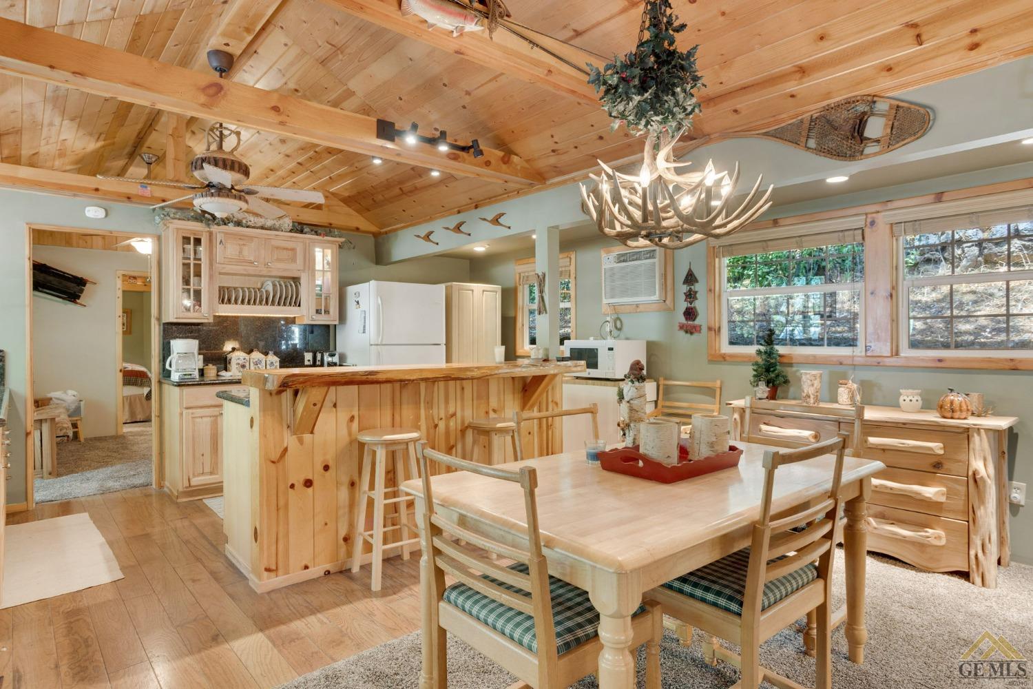 Undisclosed Address Posey, CA 93260 - Photo 16 of 50 a view of a dining room with furniture a chandelier and large windows