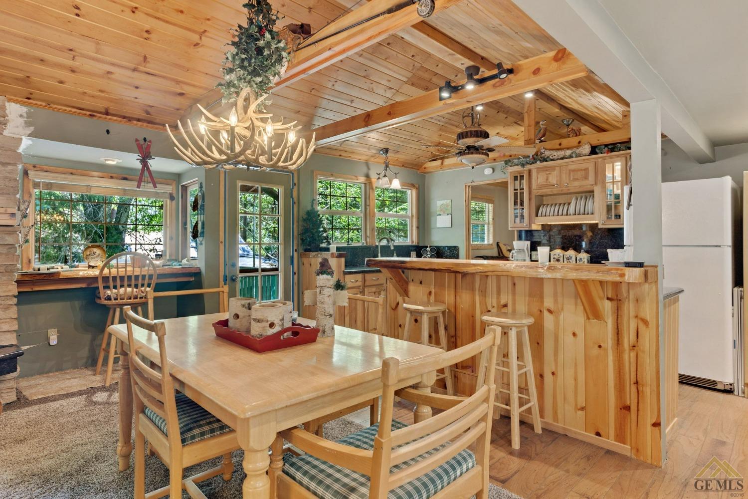 Undisclosed Address Posey, CA 93260 - Photo 17 of 50 a view of a dining room with furniture a chandelier and kitchen view