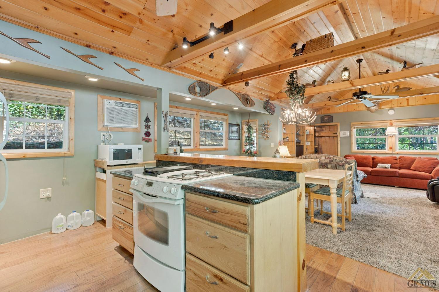 Undisclosed Address Posey, CA 93260 - Photo 24 of 50 a kitchen with a stove and a table