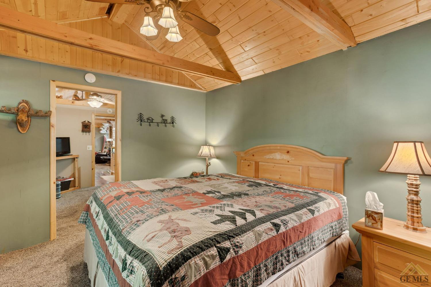 Undisclosed Address Posey, CA 93260 - Photo 32 of 50 a bedroom with a bed and a lamp on the dresser