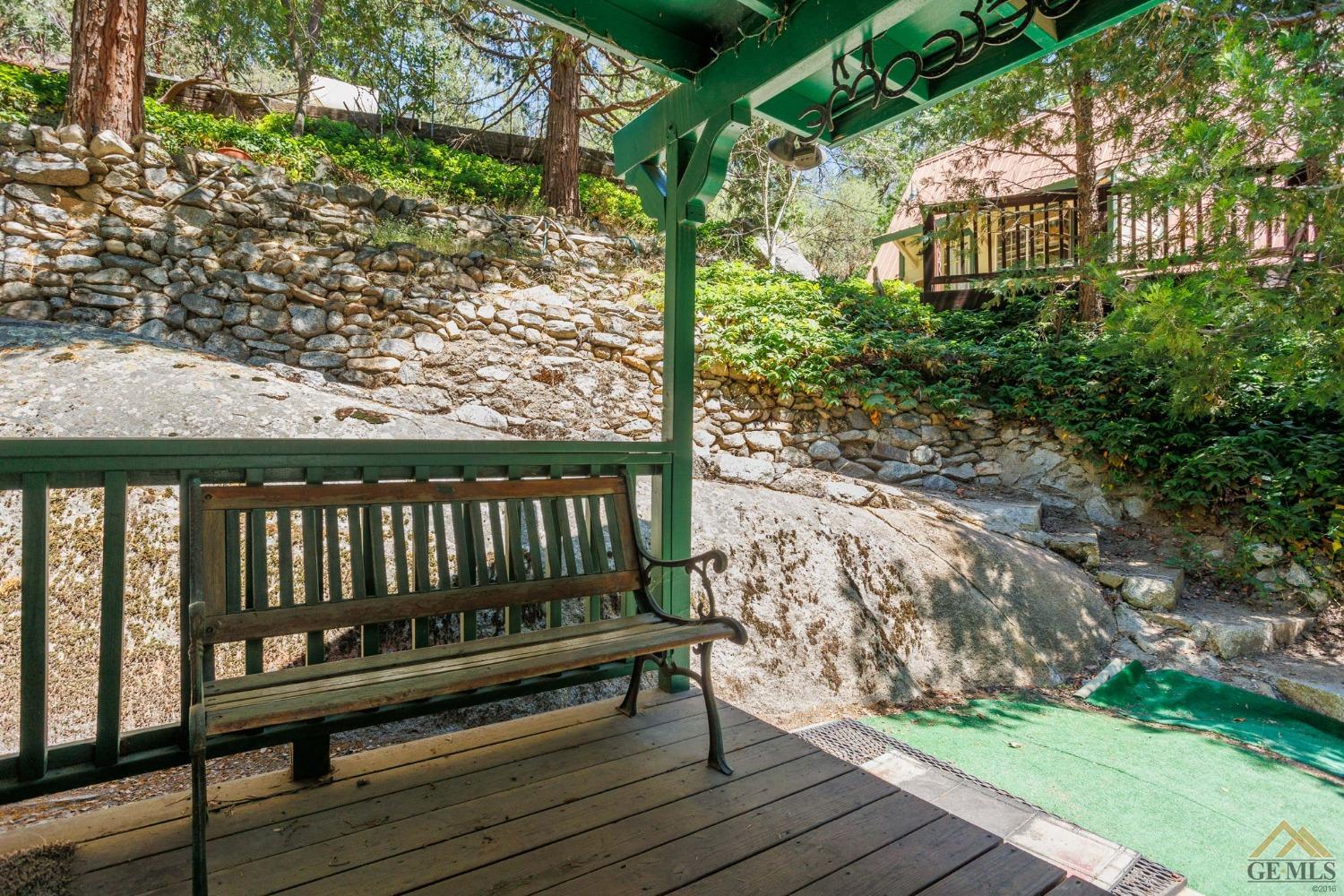 Undisclosed Address Posey, CA 93260 - Photo 5 of 50 a view of a wooden bench next to a yard