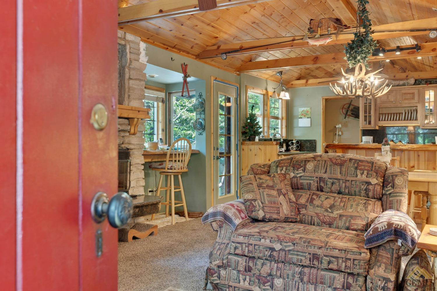 Undisclosed Address Posey, CA 93260 - Photo 6 of 50 a living room with furniture a flat screen tv and a floor to ceiling window