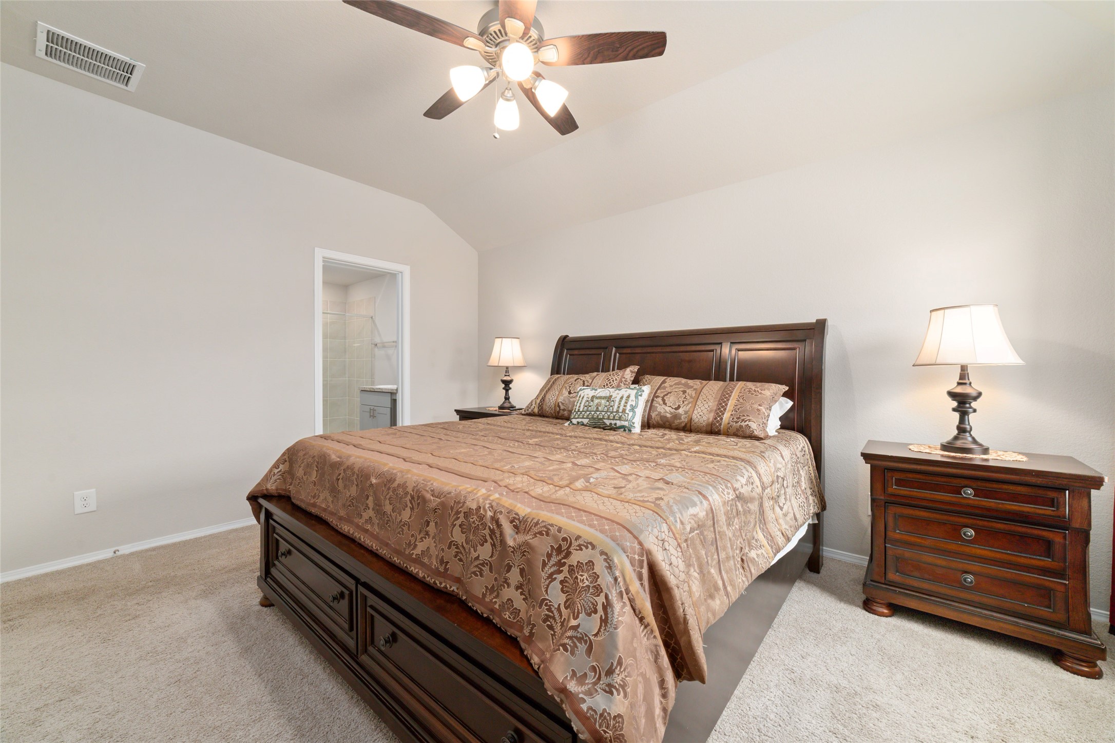 14232 Shasta Ridge Drive Conroe, TX 77303 - Photo 13 of 26 Spacious primary bedroom with high ceilings and a ceiling fan, offering a bright and airy feel with easy access to the ensuite bath.