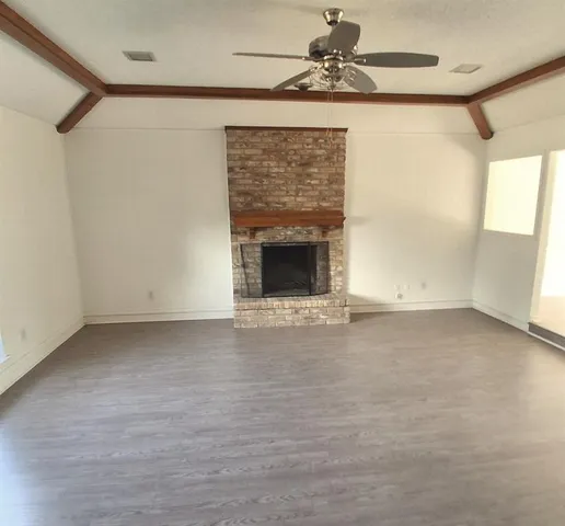 a view of an empty room with a fireplace