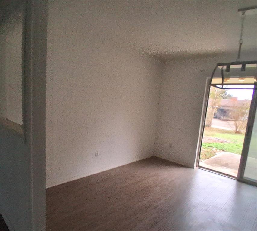 814 Oakbluff Drive Lancaster, TX 75146 - Photo 3 of 17 an empty room with wooden floor and windows