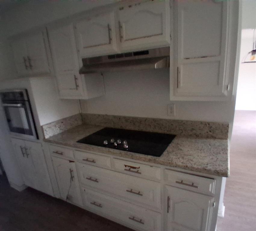 814 Oakbluff Drive Lancaster, TX 75146 - Photo 4 of 17 a kitchen with granite countertop white cabinets and a stove